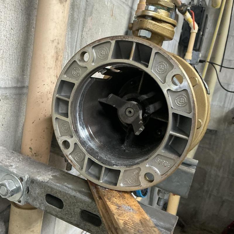 Recirculating hot water pump housing installation close-up