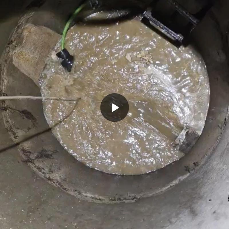 Manhole sewage system jetting to clear blockage