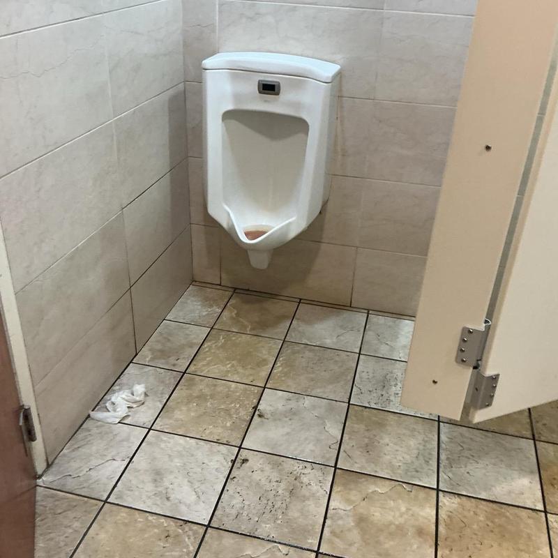 Commercial urinal drain with restroom tile flooring