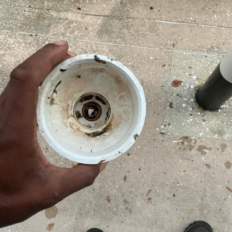Soda machine drain pipe with sludge buildup inside