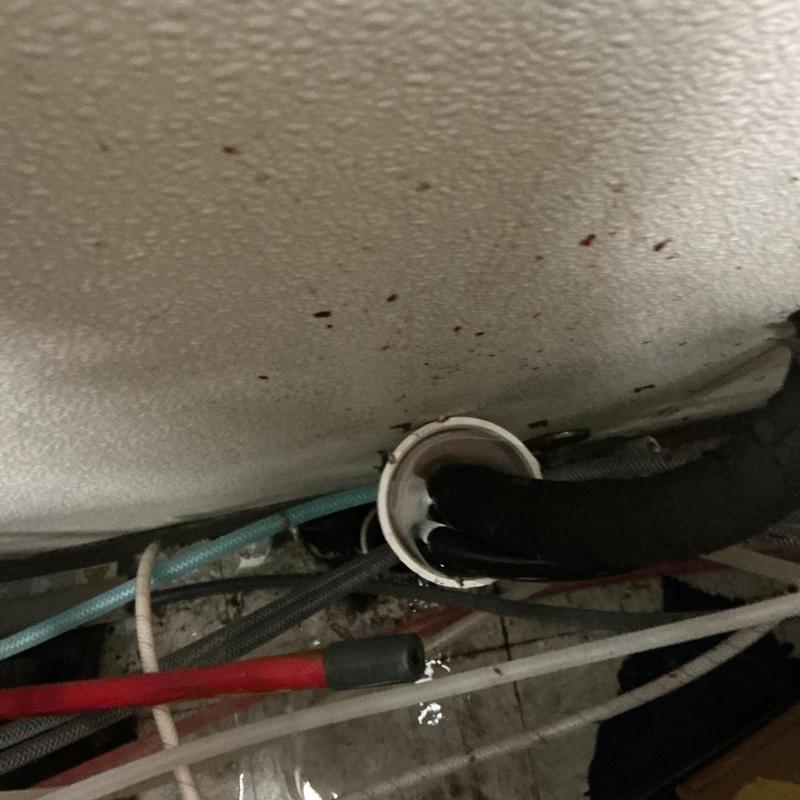 Drain pipe cleaning behind soda machine with vacuum