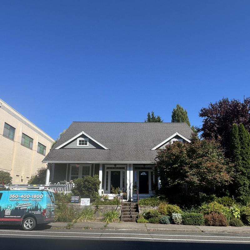 Asphalt shingle roof on residential house with service van