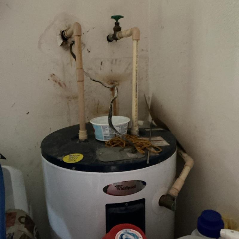 Water heater with pipe connections in indoor utility space