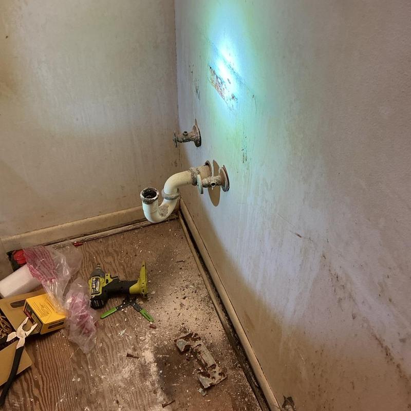 PVC drain pipe and plumbing installation area in home