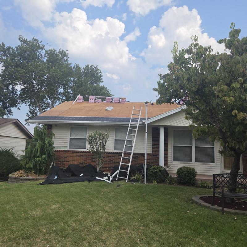Roof plywood installation with ladder and materials