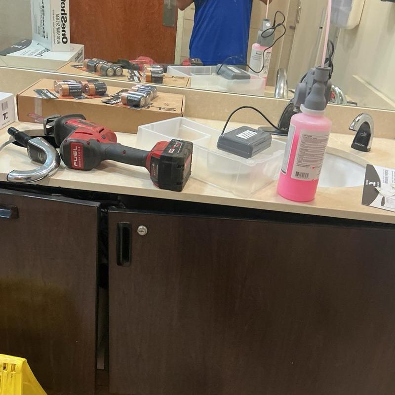 Soap dispenser installation tools on restroom sink counter