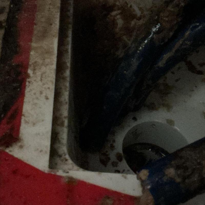 Drain pipe cleaning with hand snake and debris removal