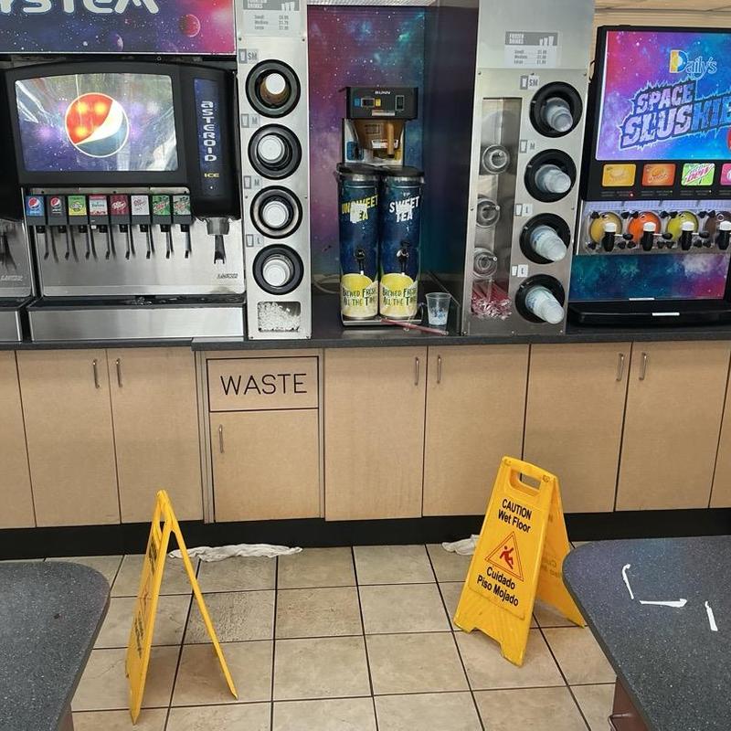 Beverage dispenser station with wet floor signs