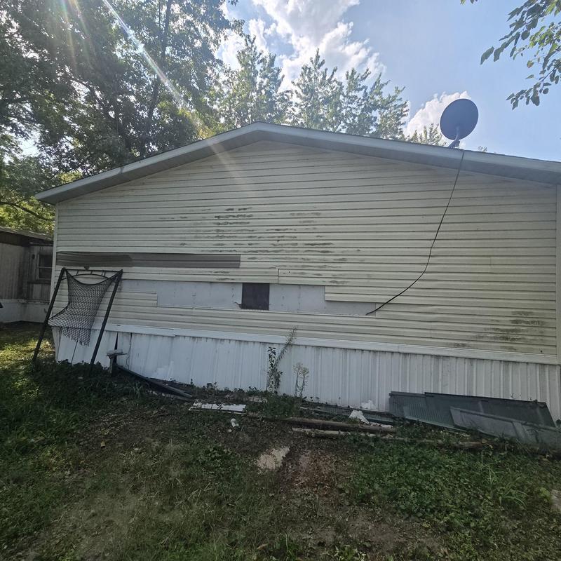 Vinyl siding damage on mobile home exterior