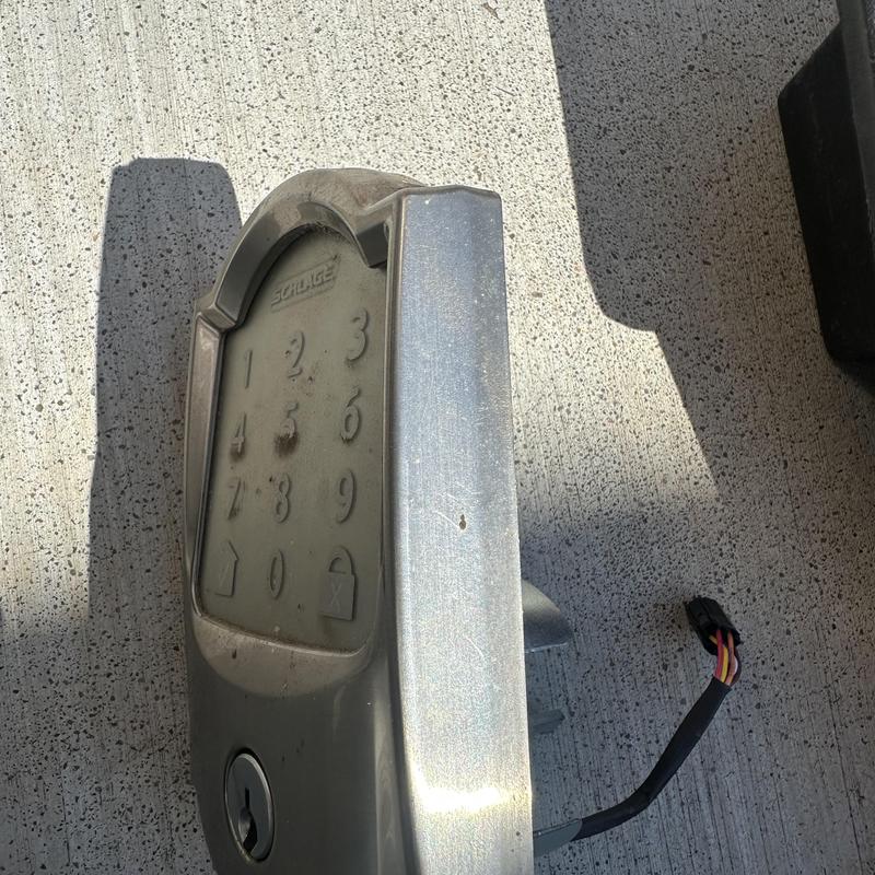 Keypad door lock with wiring harness on concrete surface Keypad door lock with wiring harness on concrete surface