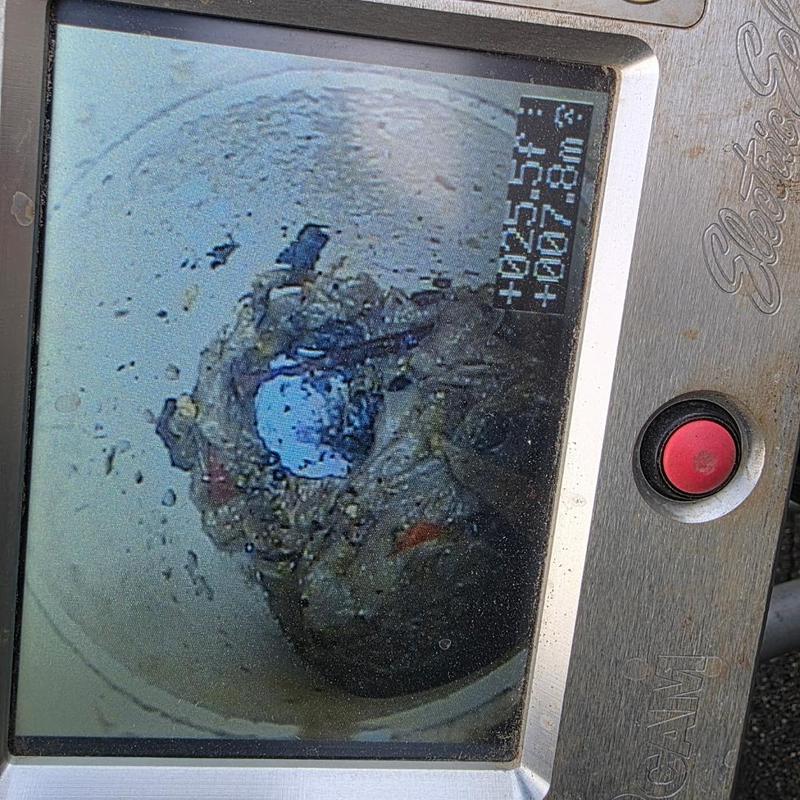Sewer camera inspection showing pipe blockage buildup