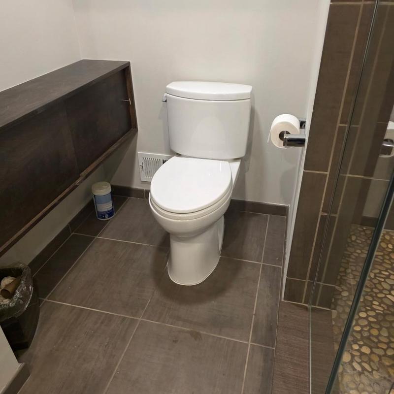 Toilet installation and reset in modern bathroom