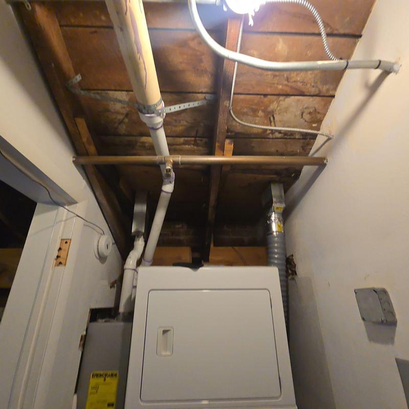 Ceiling pipe flashing with water damage above dryer