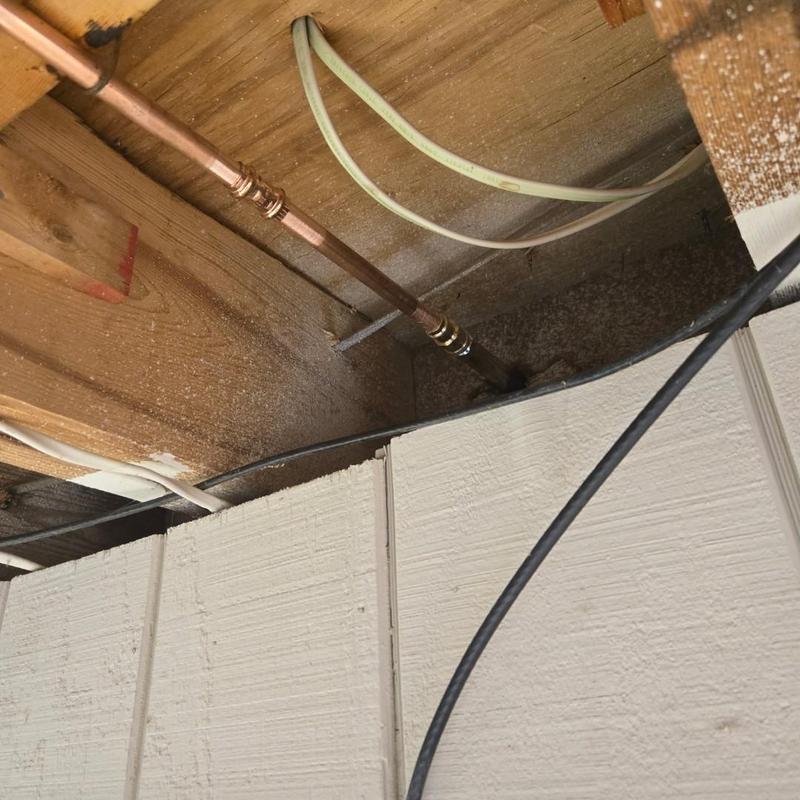 Copper water pipe with compression fittings in ceiling cavity