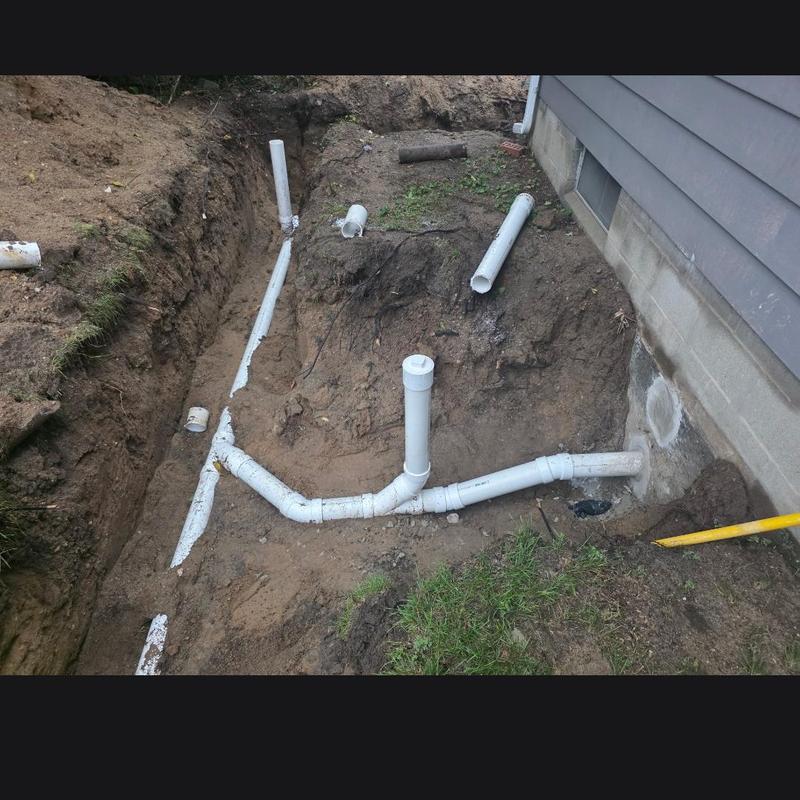 Sewer pipe installation with septic bypass near house foundation