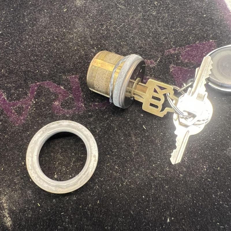 Lock cylinder with keys on dark surface Lock cylinder with keys on dark surface