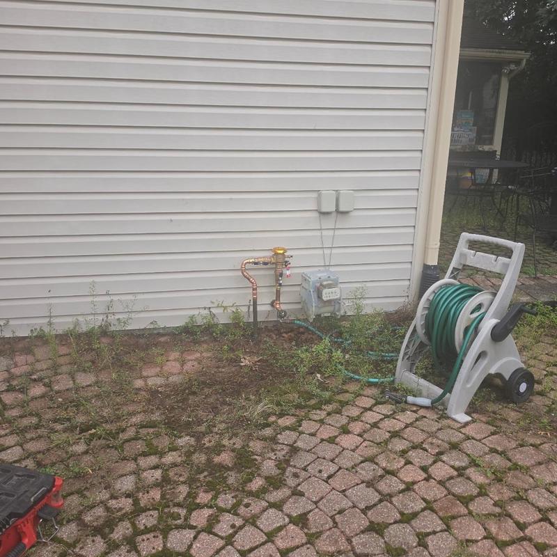 PVB backflow preventer valve installed on exterior wall PVB backflow preventer valve installed on exterior wall