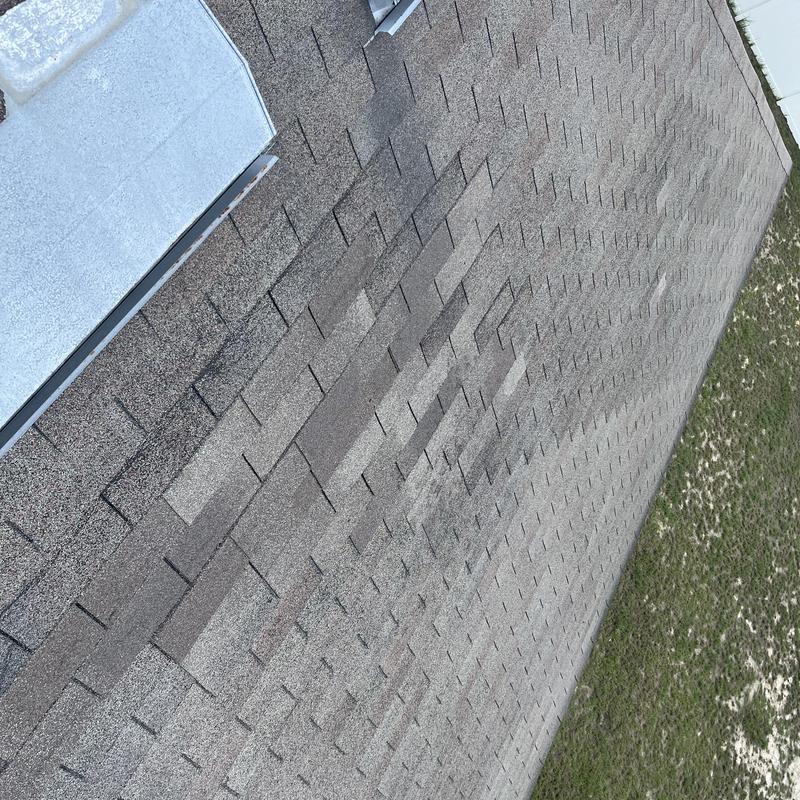 Shingle roof with discoloration near metal vent Shingle roof with discoloration near metal vent