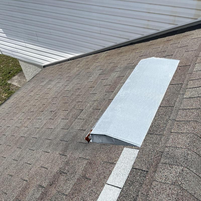 Shingle roof with metal vent cover on old roof Shingle roof with metal vent cover on old roof