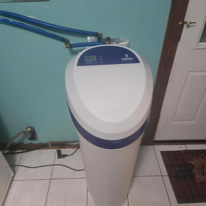 Water softener system installed near laundry area Water softener system installed near laundry area