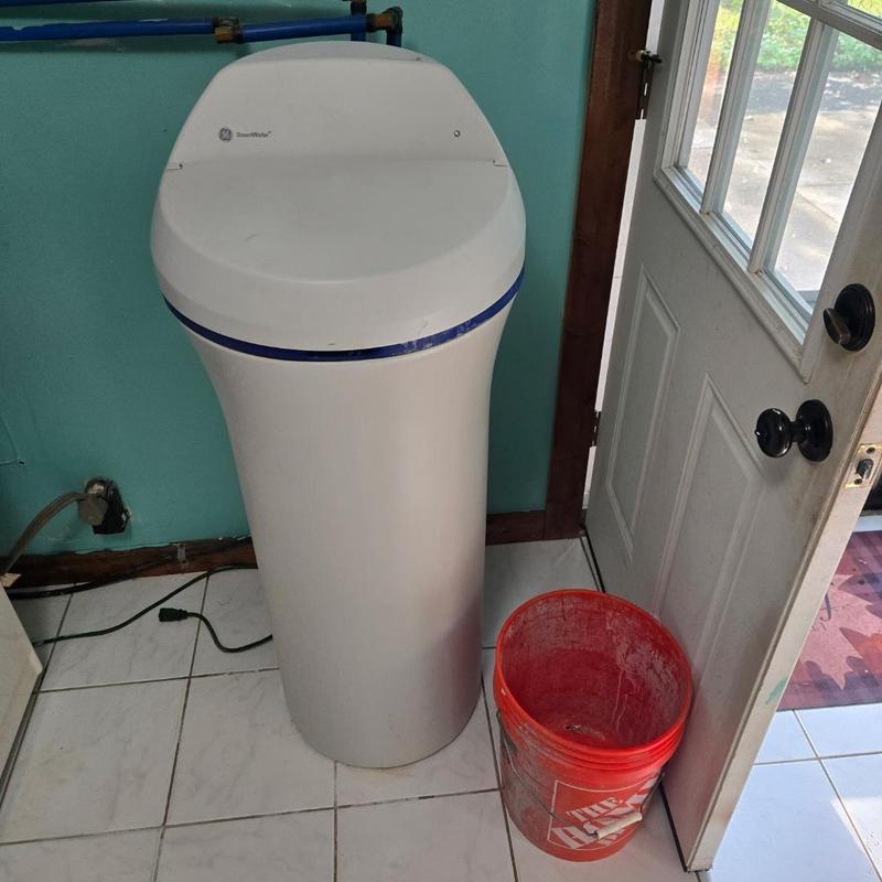 Water softener system installed in utility room Water softener system installed in utility room