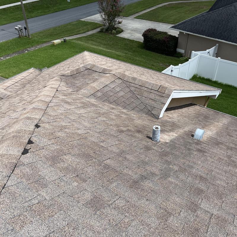 Shingle roof with vent pipes and ridges close-up Shingle roof with vent pipes and ridges close-up