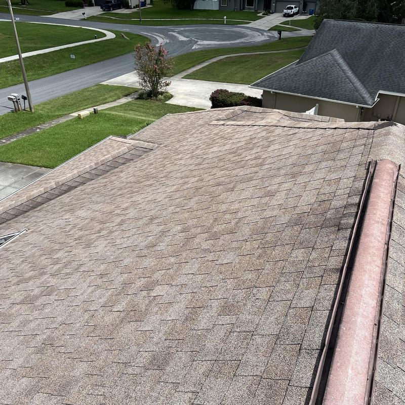 Asphalt shingle roof with visible wear and discoloration Asphalt shingle roof with visible wear and discoloration
