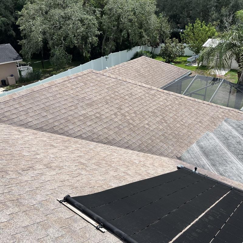 Shingle roof with solar cover and tree background Shingle roof with solar cover and tree background