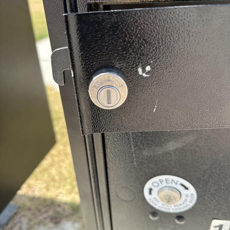 Mailbox lock replacement on black metal mailbox door Mailbox lock replacement on black metal mailbox door