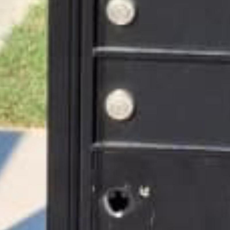 Mailbox lock hole with missing lock on black mailbox Mailbox lock hole with missing lock on black mailbox