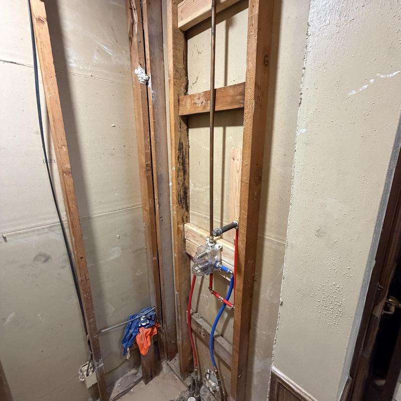 Shower valve installation with plumbing pipes exposed Shower valve installation with plumbing pipes exposed