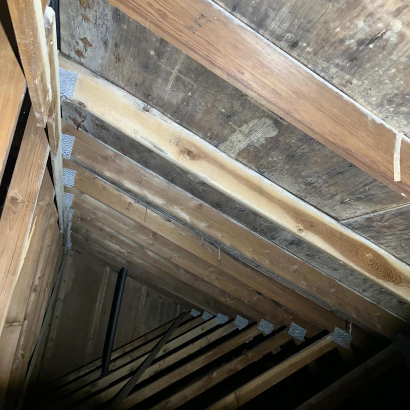 Roof sheathing and rafters inspection in attic space