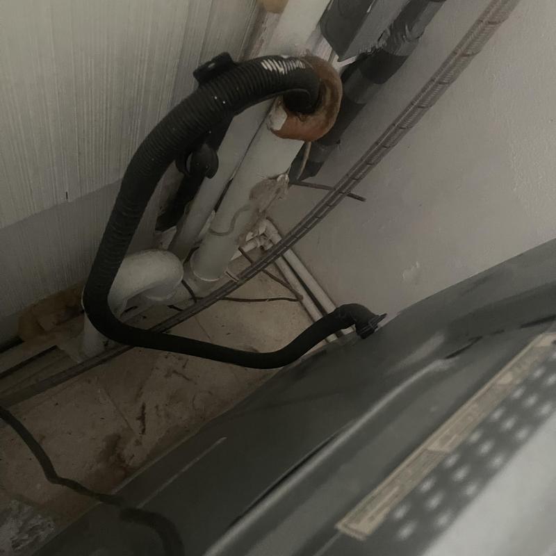 Drain hose connection to washing machine in utility room Drain hose connection to washing machine in utility room