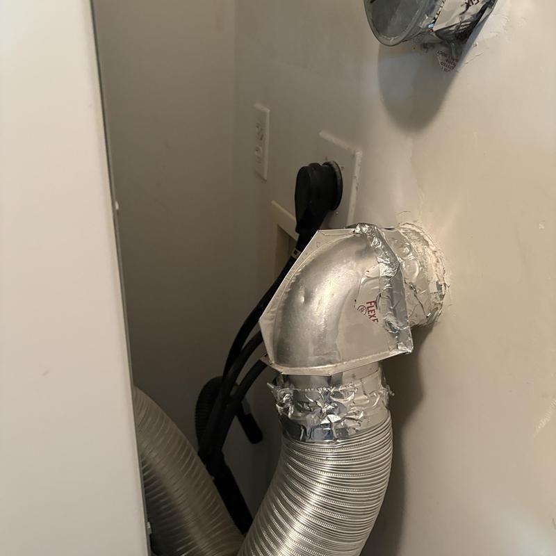 Laundry vent duct with elbow and foil tape in wall Laundry vent duct with elbow and foil tape in wall