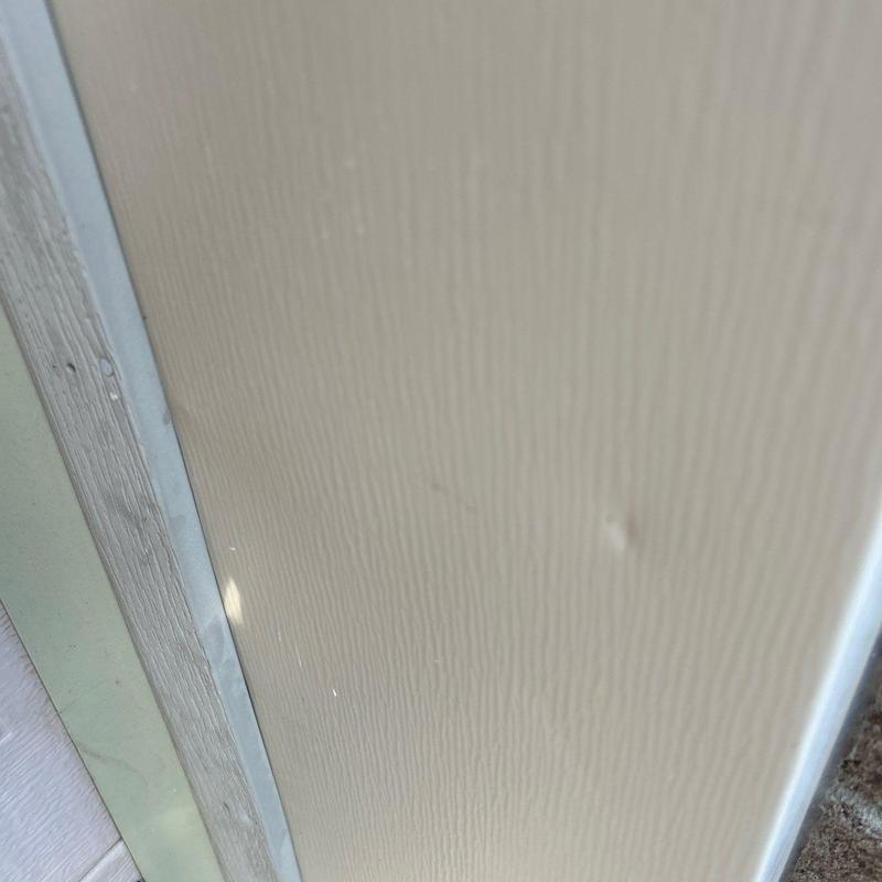 Vinyl siding panel with minor dent damage