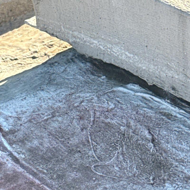 Roof membrane with damage near parapet wall base