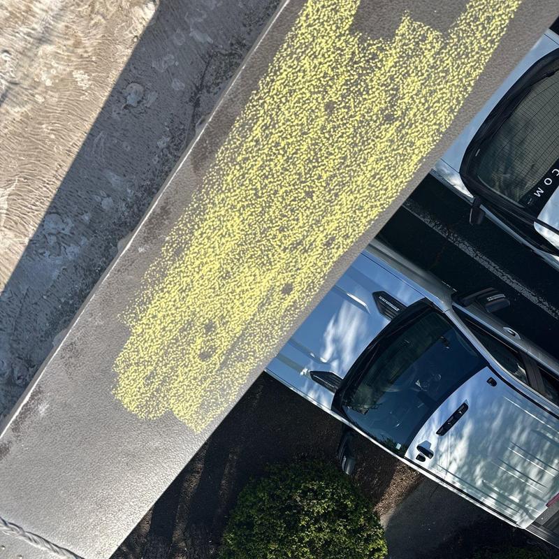 Roof coating with hail damage markings on commercial building