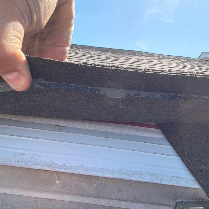 Roof shingle lifting exposing underlying structure beneath
