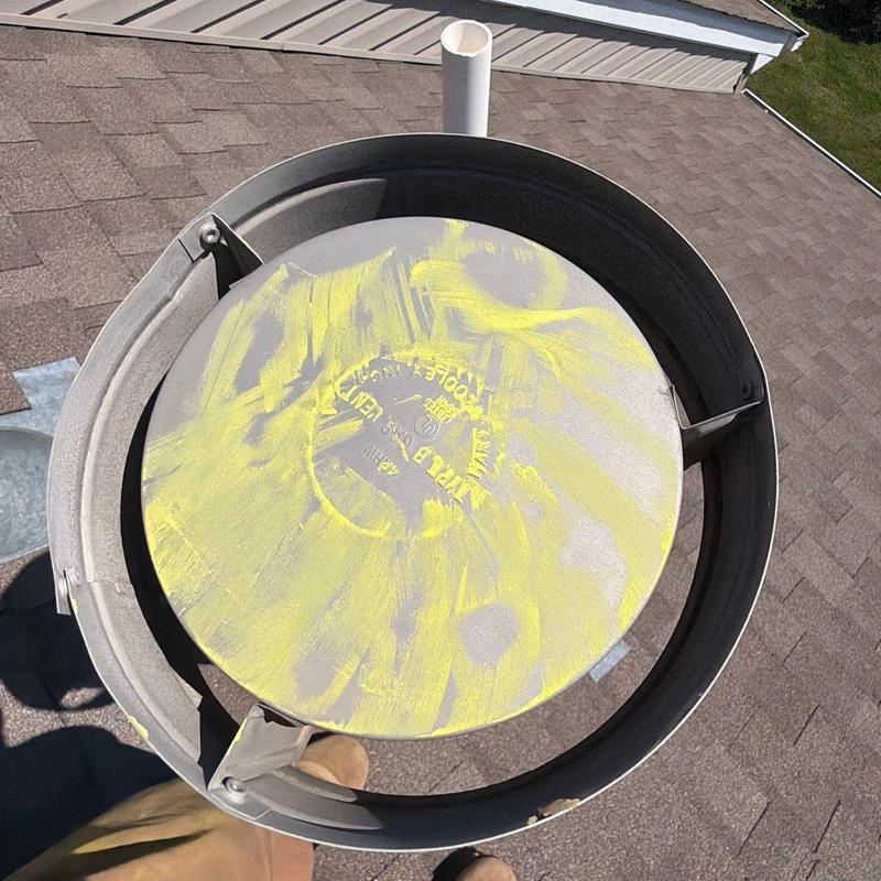 Roof vent cap with yellow inspection markings on shingles