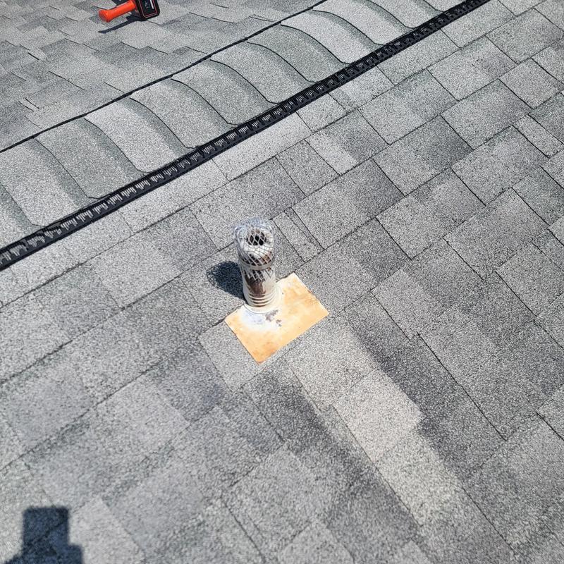 Roof vent pipe with protective cap on shingle roof Roof vent pipe with protective cap on shingle roof
