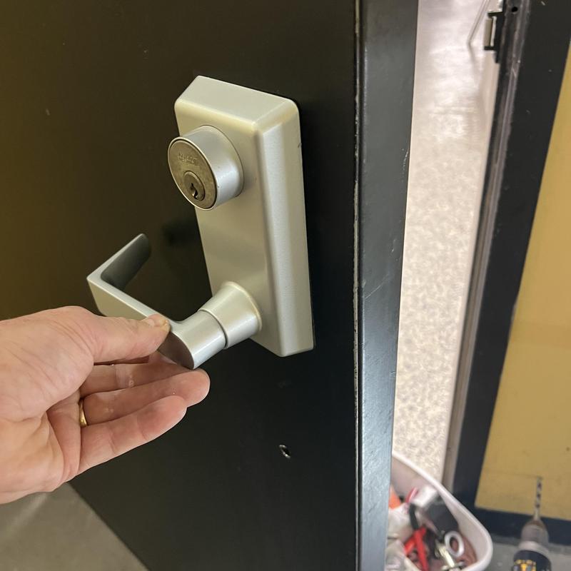 Exit device trim with key cylinder on metal door Exit device trim with key cylinder on metal door