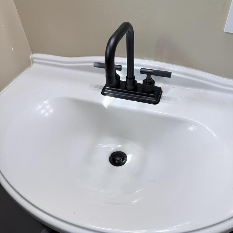 Black bathroom faucet on white sink countertop Black bathroom faucet on white sink countertop
