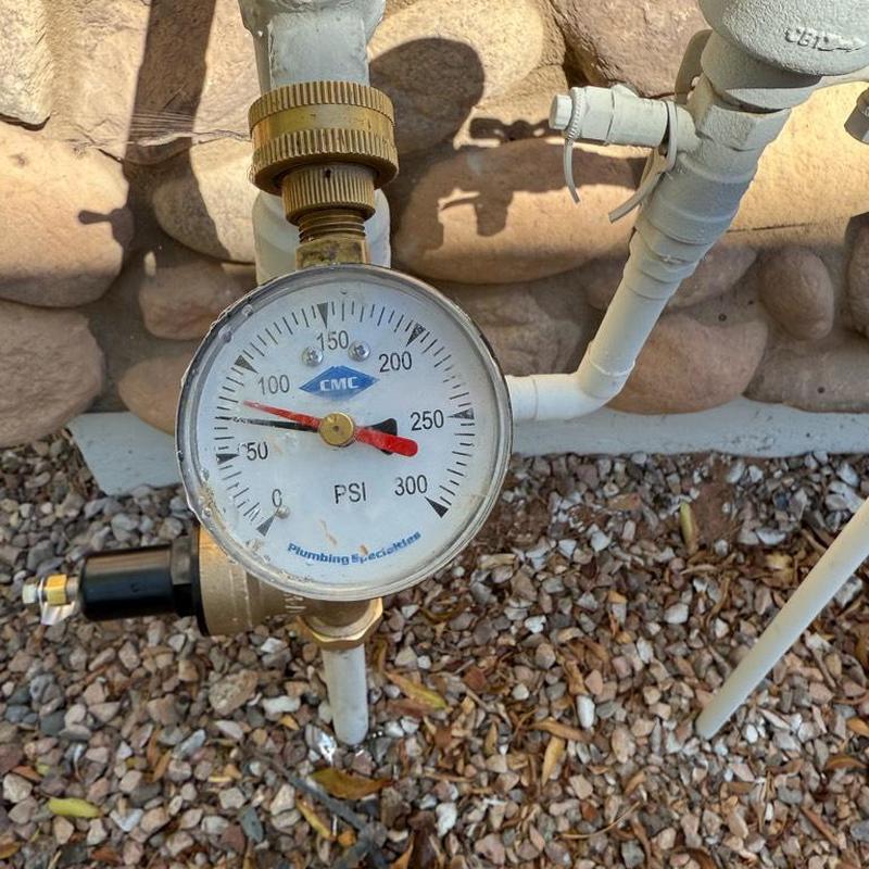 Water pressure gauge showing high PSI on plumbing line