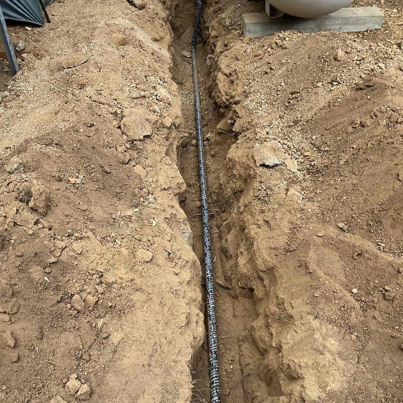 Gas line pipe in excavated trench before backfill Gas line pipe in excavated trench before backfill