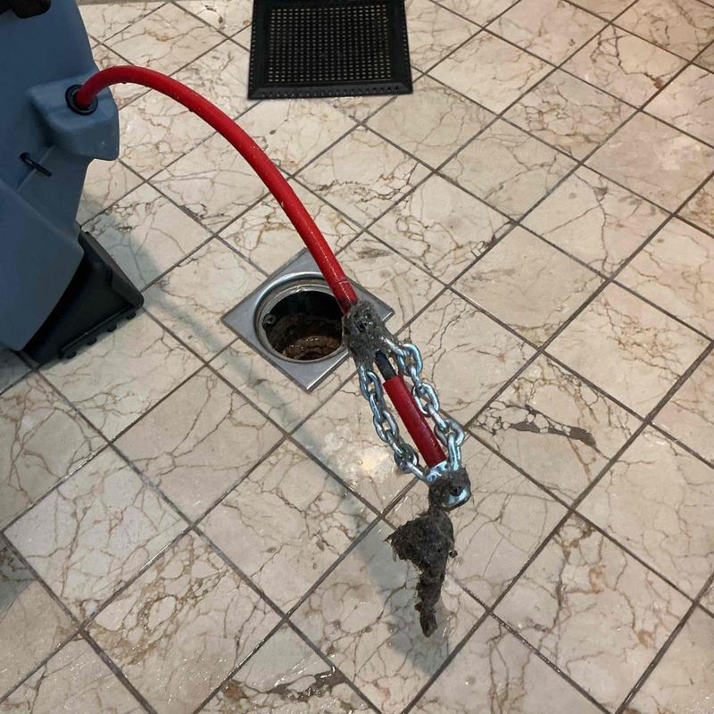 Shower drain clog removal with plumbing snake tool