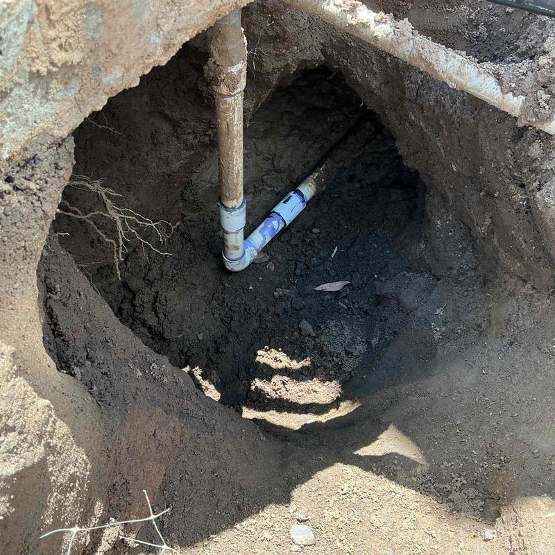 PVC pipe with new fittings installed in dirt hole PVC pipe with new fittings installed in dirt hole