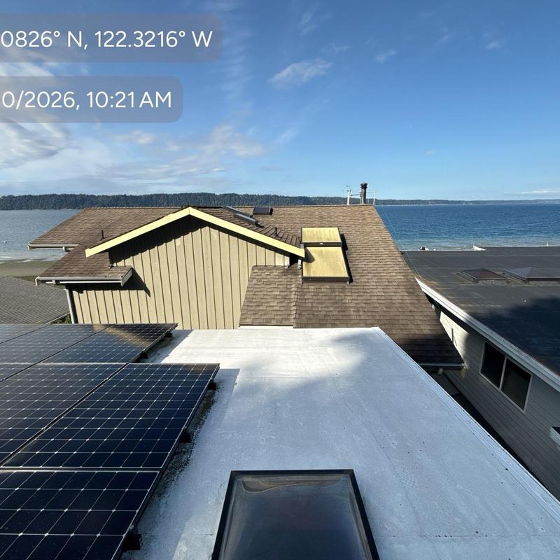Flat roof and solar panel inspection with ocean view