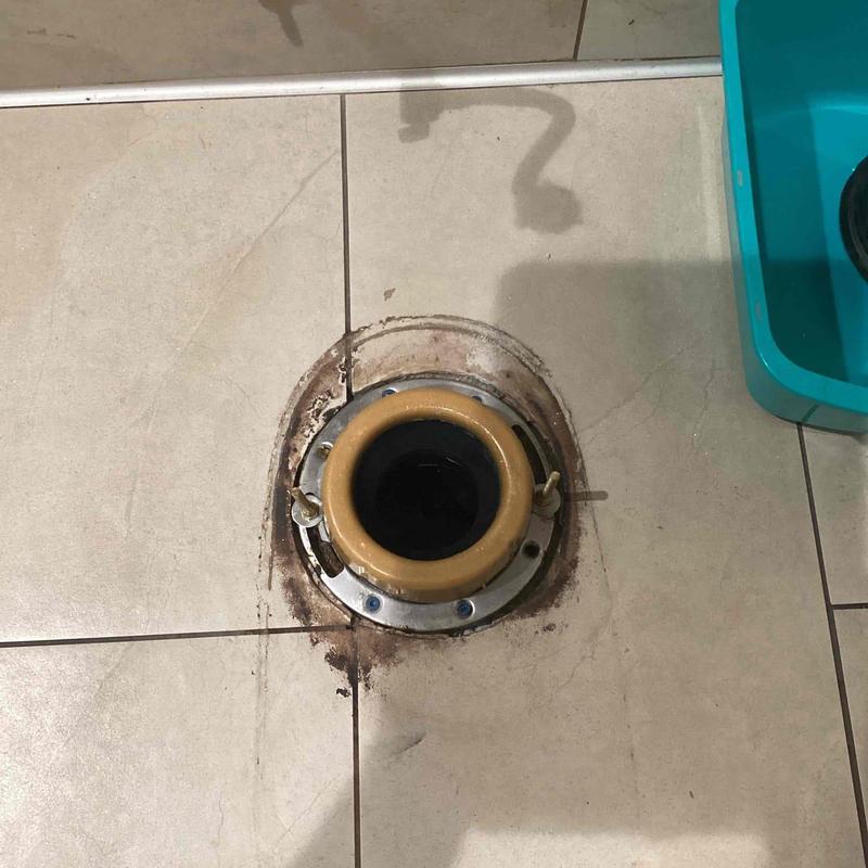 Toilet flange installed in tiled bathroom floor Toilet flange installed in tiled bathroom floor