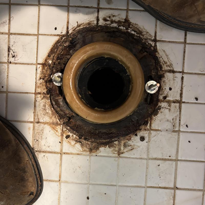 Toilet flange with new wax seal on tiled floor Toilet flange with new wax seal on tiled floor