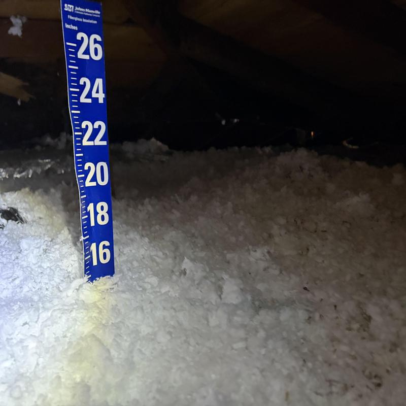Attic insulation depth measurement with ruler Attic insulation depth measurement with ruler